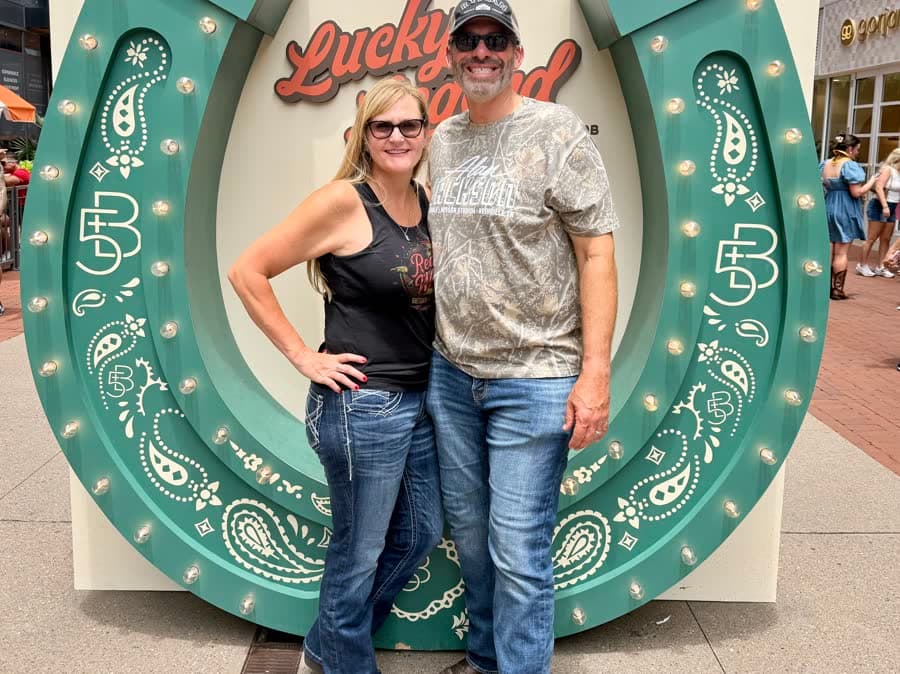 Sherri and Brett, Big Moments giveaway winners, arm in arm in front of the Lucky horseshoe sign in downtown Nashville